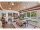 Bright dining area with a wood plank ceiling and a view of the pool and landscaping at 2515 49Th St, Sarasota, FL 34234