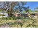 Well-maintained single-story home surrounded by lush landscaping and mature trees at 2515 49Th St, Sarasota, FL 34234