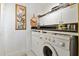 Practical laundry room with white appliances and upper cabinets at 2715 Terra Ceia Bay Blvd # 202, Palmetto, FL 34221