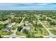Aerial view of the property with a refreshing backyard pool, gazebo, and large lawn at 3514 Laslo Ave, North Port, FL 34287