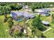 Aerial view of a backyard oasis, complete with a screened-in pool, mature landscaping, and lounging areas at 3514 Laslo Ave, North Port, FL 34287