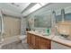 Well-lit bathroom with a shower, vanity, and ample storage space at 3514 Laslo Ave, North Port, FL 34287