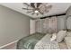 Comfortable bedroom with ceiling fan and unique barn door closet at 3514 Laslo Ave, North Port, FL 34287