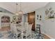 Charming dining space with rustic wood barn door, elegant lighting, and comfortable seating at 3514 Laslo Ave, North Port, FL 34287