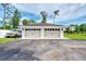 Two-car garage boasts carriage doors, dark hardware and sits on a large paved driveway at 3514 Laslo Ave, North Port, FL 34287