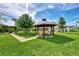 Beautiful backyard gazebo, brick path, outdoor seating, and pergola create a backyard oasis at 3514 Laslo Ave, North Port, FL 34287