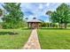Picturesque gazebo nestled within a lush green yard perfect for outdoor activities and relaxation at 3514 Laslo Ave, North Port, FL 34287