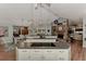 Open-concept kitchen featuring a large island with views of the dining area and fireplace at 3514 Laslo Ave, North Port, FL 34287