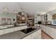 Spacious kitchen with eat-in bar, seamlessly connected to a cozy living space with fireplace at 3514 Laslo Ave, North Port, FL 34287