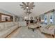 Spacious living room showcasing a large sectional, area rug, and view into other living spaces at 3514 Laslo Ave, North Port, FL 34287