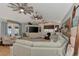 Bright living room with a large TV, decorative shelving and comfortable furniture at 3514 Laslo Ave, North Port, FL 34287