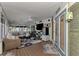 Inviting sunroom featuring comfortable seating, TV, and view to outdoors at 3514 Laslo Ave, North Port, FL 34287