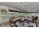 Bright sunroom featuring ample seating and views of the pool at 3514 Laslo Ave, North Port, FL 34287