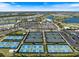 Aerial view showcasing tennis and pickleball courts with a clubhouse, golf course, and lake at 3564 Santa Caterina Blvd, Lakewood Ranch, FL 34211