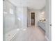 Spacious bathroom with a seamless glass shower, double vanity, and walk-in closet at 3564 Santa Caterina Blvd, Lakewood Ranch, FL 34211