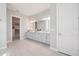 A full bathroom with double vanity, drawers and cabinets, and a walk-in closet at 3564 Santa Caterina Blvd, Lakewood Ranch, FL 34211