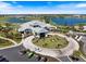 Stunning aerial view of the clubhouse featuring a circular driveway, lush landscaping, and ample parking at 3564 Santa Caterina Blvd, Lakewood Ranch, FL 34211