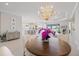 Charming dining area with a round table, chandelier, and seamless access to the living space at 3564 Santa Caterina Blvd, Lakewood Ranch, FL 34211