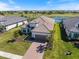 Stunning aerial view of home with tile roof, manicured lawn, and picturesque golf course backdrop at 3564 Santa Caterina Blvd, Lakewood Ranch, FL 34211
