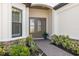 Inviting front entrance with stone accents, a double door, and lush landscaping at 3564 Santa Caterina Blvd, Lakewood Ranch, FL 34211