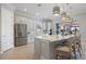 Bright, modern kitchen features stainless steel appliances, pendant lighting, and a large island with bar seating at 3564 Santa Caterina Blvd, Lakewood Ranch, FL 34211