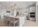Modern kitchen featuring stainless steel appliances, a large island with seating, and stylish pendant lights at 3564 Santa Caterina Blvd, Lakewood Ranch, FL 34211