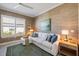Cozy sitting room with white sofa, textured wallpaper, and bright window at 3564 Santa Caterina Blvd, Lakewood Ranch, FL 34211
