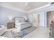 Serene main bedroom boasts elegant blue accents, a ceiling fan, and an en-suite bathroom with a glass shower at 3564 Santa Caterina Blvd, Lakewood Ranch, FL 34211
