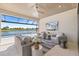 Inviting outdoor living area featuring comfortable seating, ceiling fans, and panoramic views of the lake and pool at 3564 Santa Caterina Blvd, Lakewood Ranch, FL 34211