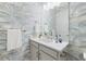 Stylish powder room with blue wallpaper and a white vanity and brushed nickel faucet at 3564 Santa Caterina Blvd, Lakewood Ranch, FL 34211
