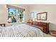 Bright bedroom featuring a large window with serene views and a cozy sitting area at 3750 Summerwind Cir, Bradenton, FL 34209