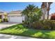 Lovely home showcases lush green lawn, tropical landscaping and a brick paver driveway at 3750 Summerwind Cir, Bradenton, FL 34209