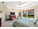 Inviting main bedroom with ceiling fan, tray ceiling, large window, and calming neutral tones at 3750 Summerwind Cir, Bradenton, FL 34209