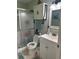 Bright bathroom with a shower, toilet, vanity, and a cabinet for storage at 3784 59Th W Ave # 3784, Bradenton, FL 34210