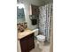 Cozy bathroom featuring a vanity with a sink, toilet, and a shower with a patterned curtain at 3784 59Th W Ave # 3784, Bradenton, FL 34210