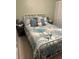 Bright bedroom with a white metal frame bed, nautical themed comforter and shams at 3784 59Th W Ave # 3784, Bradenton, FL 34210