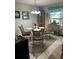 Dining room with ornate chairs, decorative chandelier and light coming through the window at 3784 59Th W Ave # 3784, Bradenton, FL 34210