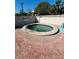 Outdoor hot tub area surrounded by brick, a fence, and palm trees at 3784 59Th W Ave # 3784, Bradenton, FL 34210