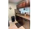 Kitchen featuring dark cabinetry, granite countertops, and stainless steel appliances at 3784 59Th W Ave # 3784, Bradenton, FL 34210