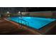 Outdoor pool and lounge area with ladder and lighting, perfect for evening swims at 3784 59Th W Ave # 3784, Bradenton, FL 34210