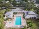 Aerial shot of a community pool with a hot tub, lounge seating, and attractive landscaping at 3790 Pinebrook Cir # 103, Bradenton, FL 34209