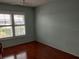 Bedroom with hardwood floors and a large window with white shutters and ceiling fan at 3790 Pinebrook Cir # 103, Bradenton, FL 34209