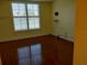 Bedroom featuring hardwood floors and a large window with white shutters at 3790 Pinebrook Cir # 103, Bradenton, FL 34209