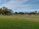 Scenic golf course view with trees and a pond on a sunny day at 3790 Pinebrook Cir # 103, Bradenton, FL 34209