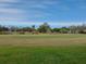 Expansive view of the golf course with manicured greens and community in background at 3790 Pinebrook Cir # 103, Bradenton, FL 34209