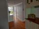 Hallway with hardwood flooring, large wall closet and a view to the lanai at 3790 Pinebrook Cir # 103, Bradenton, FL 34209