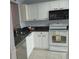 Bright kitchen features white cabinets, black granite countertops, and stainless steel appliances at 3790 Pinebrook Cir # 103, Bradenton, FL 34209
