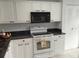 Bright kitchen with white cabinets, granite countertops, and modern appliances for efficient cooking at 3790 Pinebrook Cir # 103, Bradenton, FL 34209