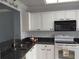 Bright kitchen featuring white cabinets, granite countertops, and modern appliances for a stylish cooking space at 3790 Pinebrook Cir # 103, Bradenton, FL 34209