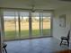 Tiled lanai boasting golf course views through large glass windows at 3790 Pinebrook Cir # 103, Bradenton, FL 34209